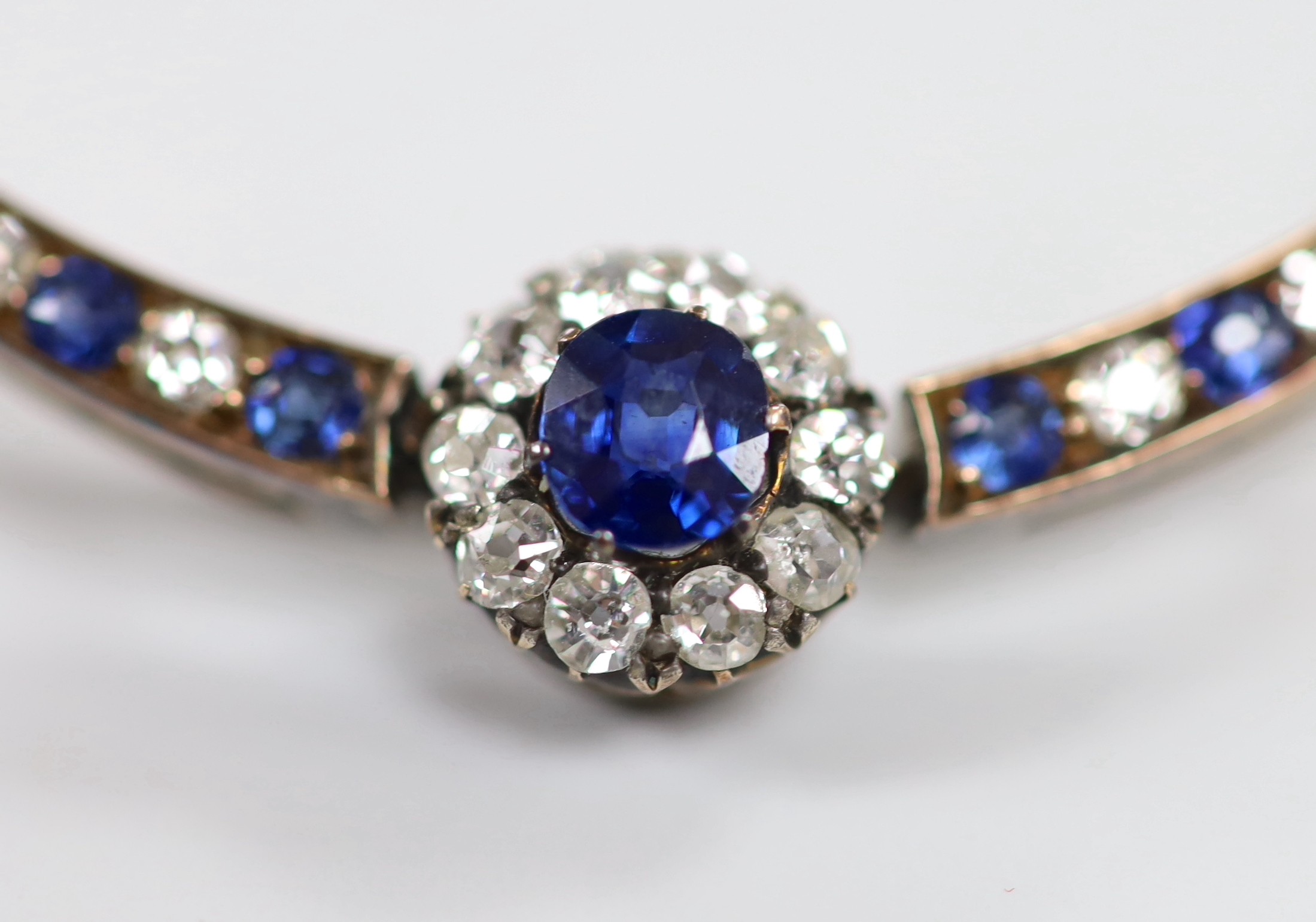 A Victorian yellow metal, sapphire and diamond cluster set crescent brooch, 42mm, gross weight 3.9 grams.